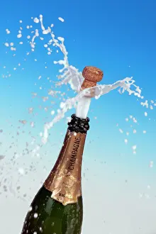 Foam: Champagne cork shooting out of the bottle