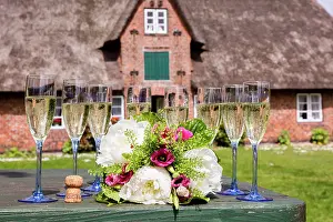 Celebrations: Champagne glasses and bouquet in front of museum