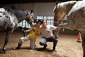 Balancing: Child and monitor posing with horses in balance