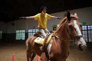 Halter: Child performing a balancing act on a horse