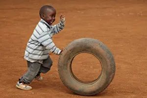 Tribal: Child playing with tire, near Eldoret, Kenya, Kalingen