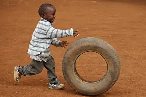 Tribal: Child playing with tire, near Eldoret, Kenya, Kalingen