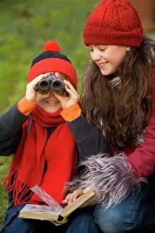 Binoculars: Children - boy and girl birdwatching with binoculars
