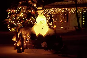Snowmen: Christmas lights and Snowman on old waggon with logs