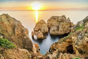 Arches: Cliffs and arches in Ponta da Piedade at sunrise