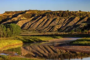 North Dakota: Cliffs reflection in the Little Missouri River at sunrise in