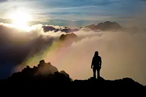 Experience: Climber at the summit, sunrise above clouds, Tatra