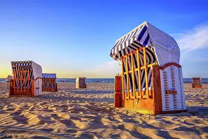Basket: closed beach chairs against a sunset
