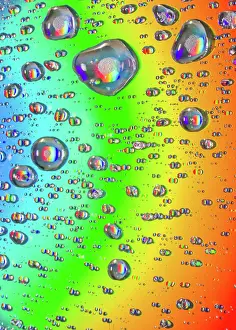 Prismatic: Closeup of water drops on field of beautiful rainbow