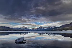 Montana: Clouds reflect in opening in the ice on Lake McDonald in