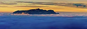 Towering: From the clouds towering mountain massif Hochthron