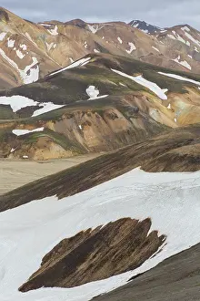 Remains: Colored rhyolite mountains with remains of snow