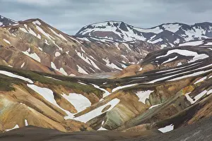 Remains: Colored rhyolite mountains with remains of snow