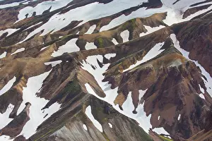Remains: Colored rhyolite mountains with remains of snow