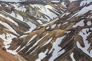 Remains: Colored rhyolite mountains with remains of snow