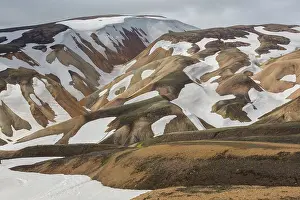 Remains: Colored rhyolite mountains with remains of snow
