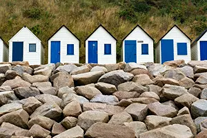 Cottages: colorful row of small wooden beach cottages on the