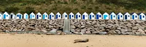 Cottages: colorful row of small wooden beach cottages on the