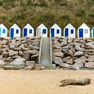 Cottages: colorful row of small wooden beach cottages on the
