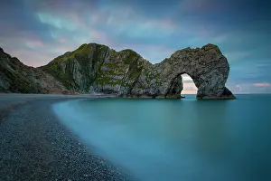 Features: Colorful sky at dawn over Durdle Door along the