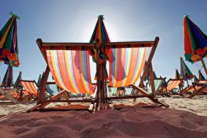 300517: Colourful beach umbrellas and deckchairs for a summer ho