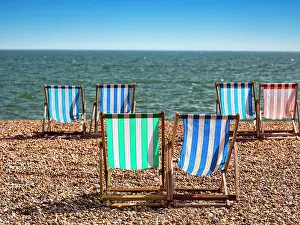Gravel: Colourful deckchairs by the sea, paired folding