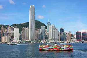 Crossing: Colourful Ferry crossing Victoria Harbour and Skyline, Hong