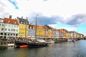 Canal: Copenhagen, Denmark. Nyhavn, painted houses by canal