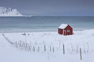 Desolation: Cottage at snowy coast - Lofoten - Norway