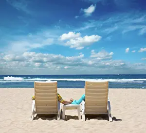 Silence: Couple in beach chairs holding hands near ocean