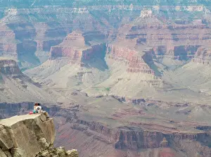 Spur: Couple on a rock spur at the South Rim high above