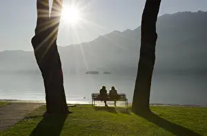 Bench: Couple sitting on a bench, lakefront, alpine lake
