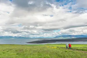 Lava: Couple walking to the beach of Vatsnes Peninsula in Iceland