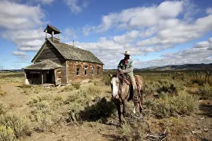 1900: Cowboy on horse by old 1900's school building