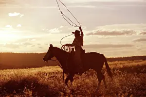 Ranches: Cowgirl riding Quarter / Paint Horse