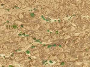Thomas Dressler: Cracked earth and dried up streams with sparse desert vegetation