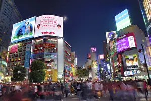 Transport: Crowds crossing Shibuya Scramble crossing at dusk, Shibuya