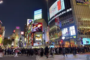 Transport: Crowds crossing Shibuya Scramble crossing at dusk, Shibuya