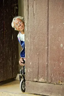 Habana: Cuba - Old woman on a wheelchair at the front door