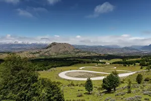 Leads: Curvy road Carretera Austral leads through green