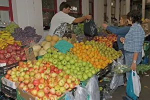 Selling: Cusomers buying fruit in market at Vila do Conde