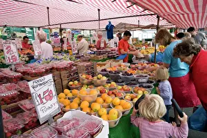 Selling: Customers buying fruit and vegetables at Saturday market