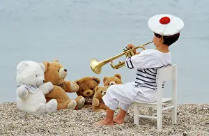 Trumpets: Cute - child on beach with teddy bears & trumpet