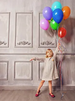 Vintage: Cute little girl in retro style holding balloons