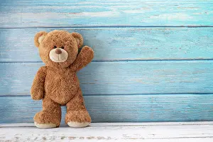 Loneliness: Cute teddy bear with copy space on blue color wood b
