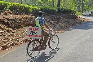 Bicycles: Cyclist with a sign warning motorists of wildlife