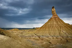 Rainy: Dark clouds and rain as background of the Castildeterra rock formation in the Bardenas Blanca area of the Bardenas