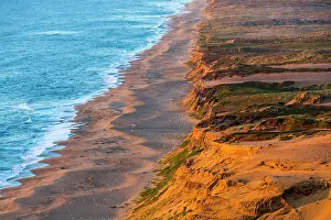 Reyes: Days last light strikes the sandy shore
