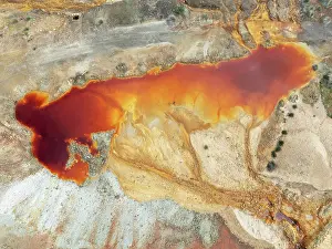 Mining: Deep orange-red hues in the water of a pool in the mineral-rich area of the Rio Tinto mines