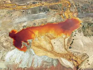 Mining: Deep orange-red hues in the water of a pool in the mineral-rich area of the Rio Tinto mines